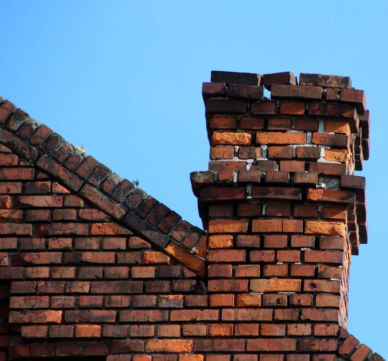 Damaged chimney on an Ypsilanti home showing cracks and missing mortar